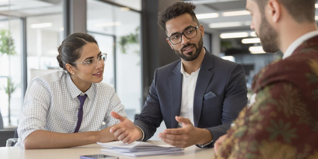 Business owner negotiating with payment processor in an office.